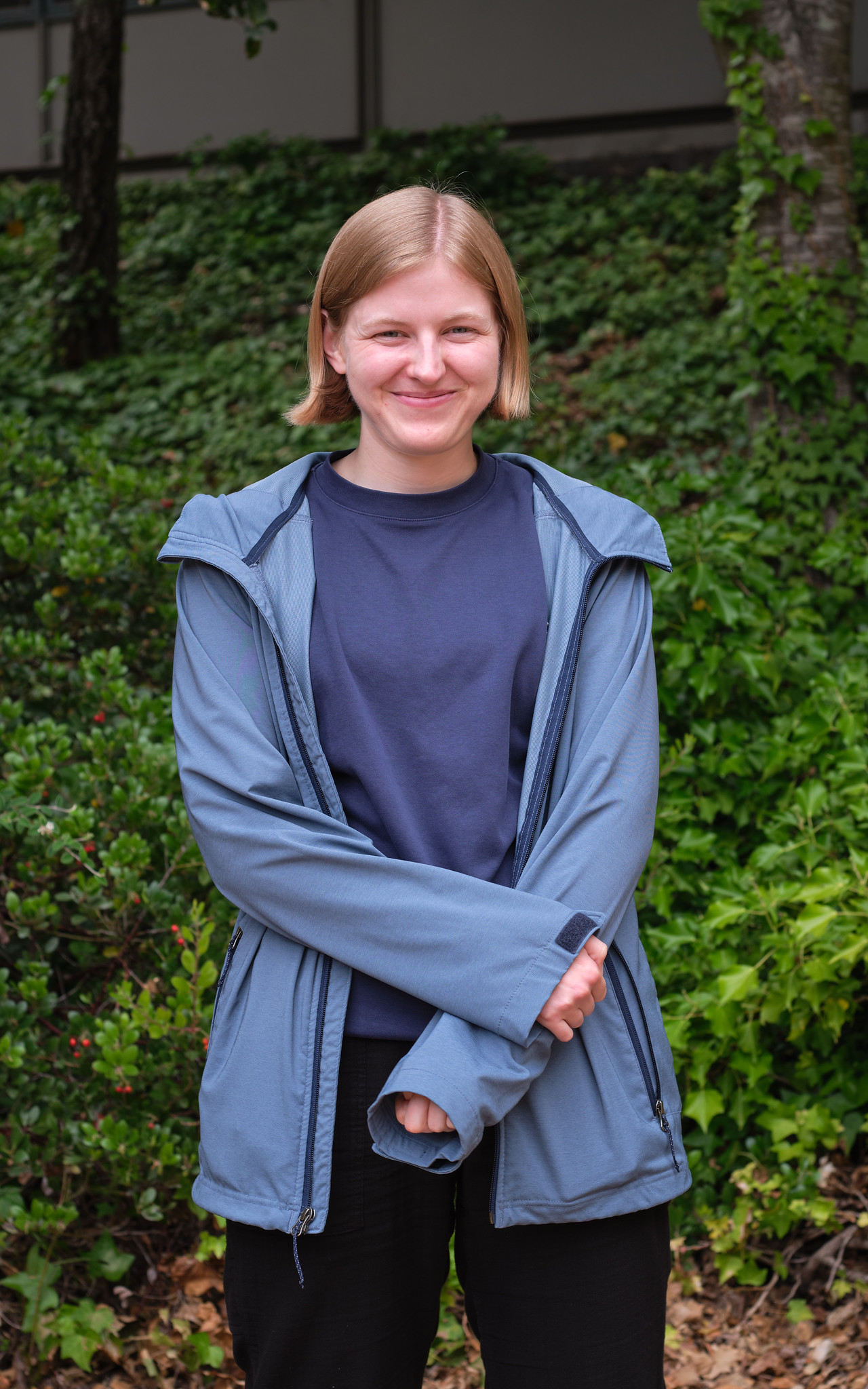 Picture of me, in front of some greenery.